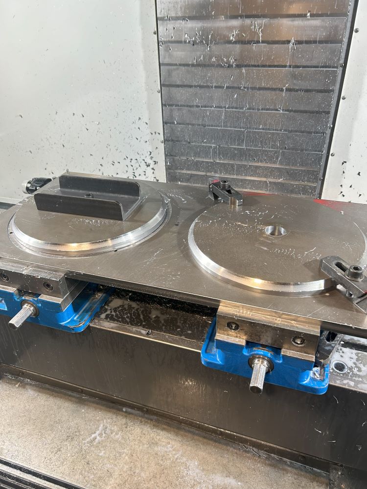 Flagpole base assembly fixture inside HAAS VF3YT machining center